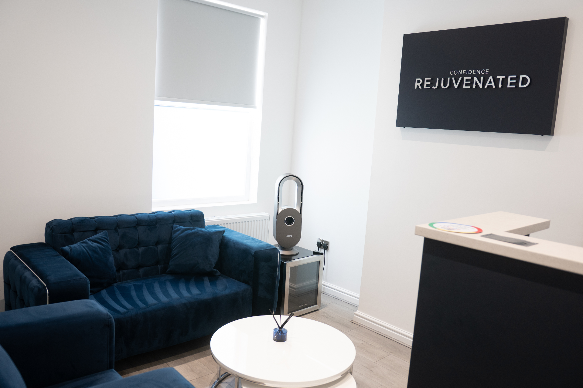 Calm waiting area at Re-Ignite Dental with navy seating